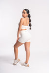 Women’s stylish white activewear set with high-waisted shorts and sports bra