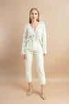 Soft white cardigan sweater with buttons and full-length sleeves for comfort