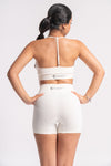 Women’s white gym set with high-waist shorts and supportive sports bra