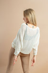 Women's white sweater with batwing sleeves, a versatile wardrobe essential for fall